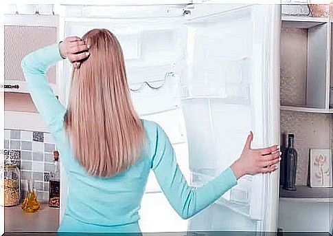 Woman with empty refrigerator